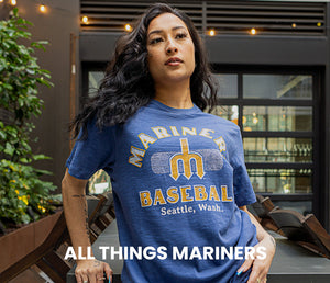 Shop All Things Mariners, Portrait of Model Wearing A Mariners T-shirt.
